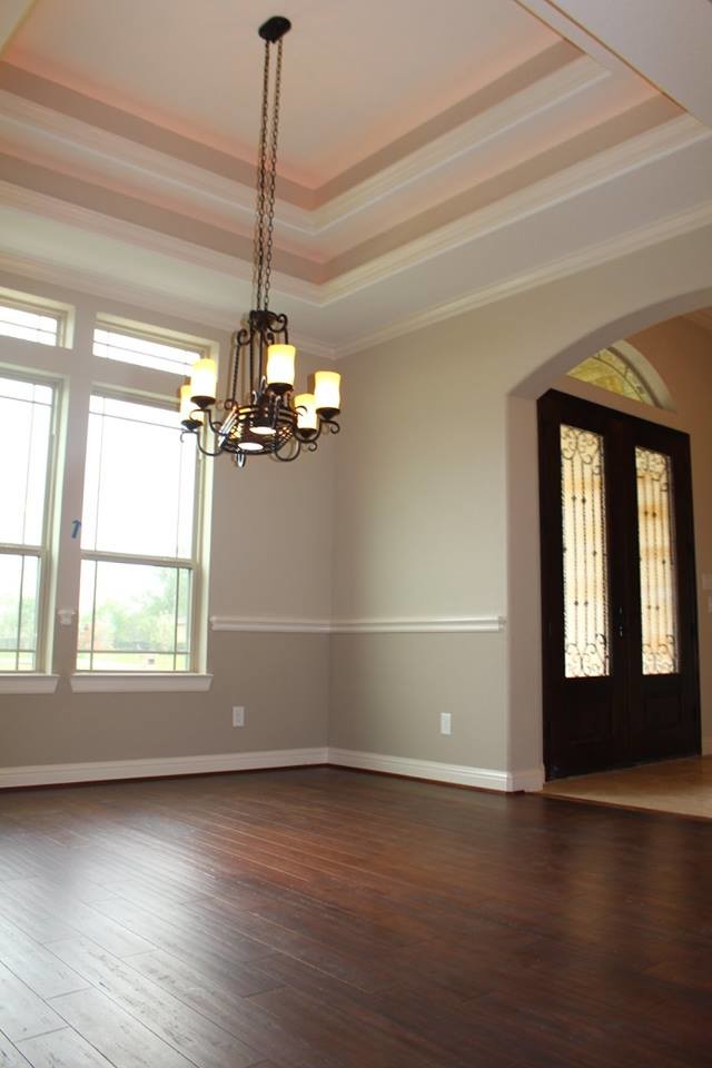 Mid-sized elegant formal and open concept dark wood floor living room photo in Houston with beige walls and no fireplace