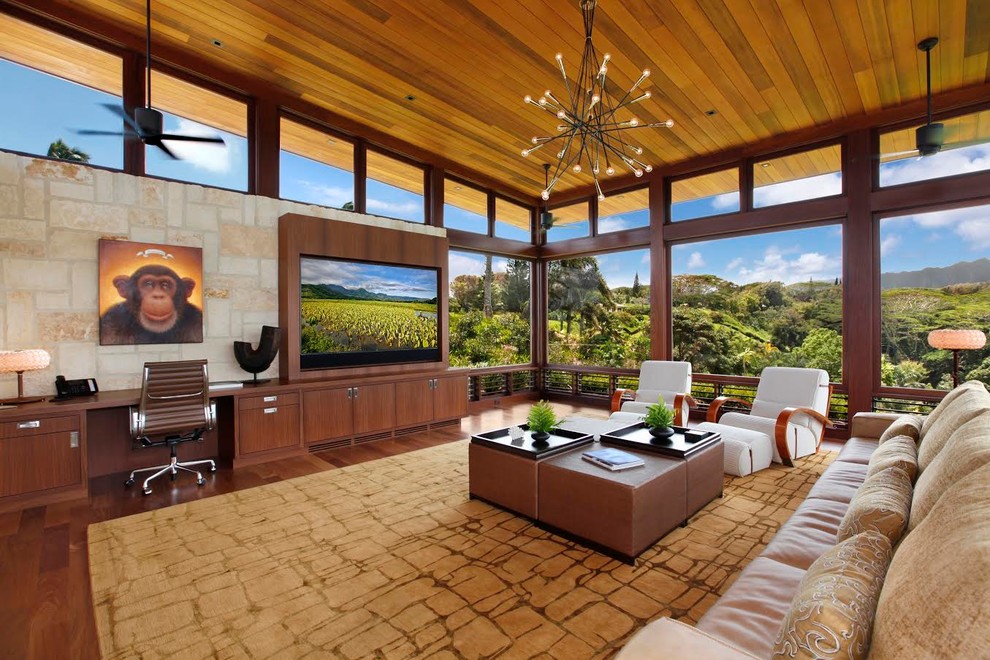 This is an example of a large contemporary open plan living room in Hawaii with no fireplace, a wall mounted tv, medium hardwood flooring and brown floors.