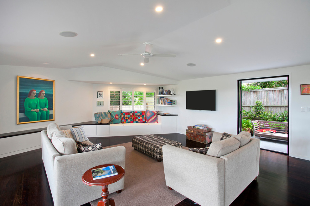 Mid-sized trendy open concept dark wood floor living room photo in Sunshine Coast with white walls and a wall-mounted tv