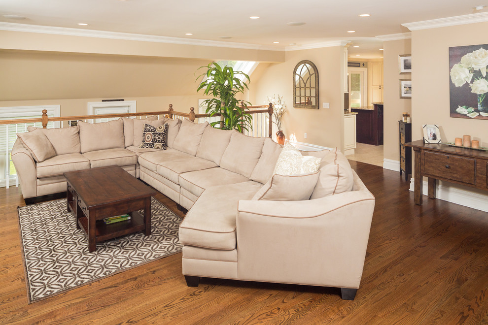 Living room - mid-sized traditional open concept medium tone wood floor living room idea in New York with beige walls
