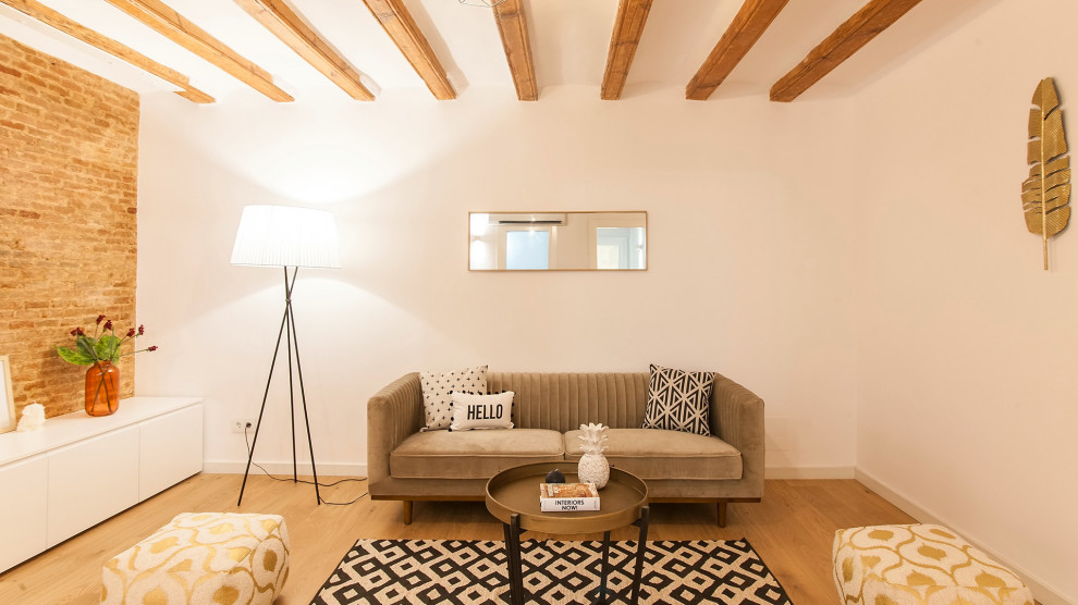 Example of a small urban loft-style light wood floor living room design in Barcelona with brown walls