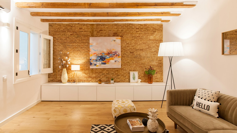 Example of a small urban loft-style light wood floor living room design in Barcelona with brown walls