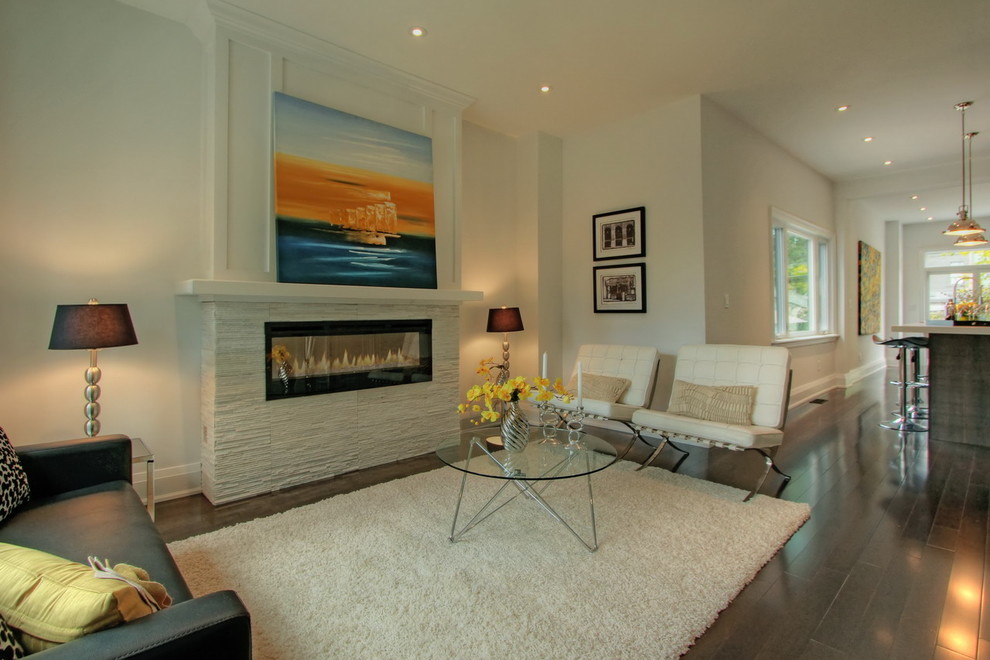 Design ideas for a modern living room in Toronto with a stone fireplace surround and feature lighting.