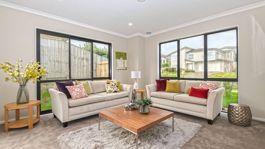 Medium sized contemporary living room in Auckland with grey walls, carpet and grey floors.