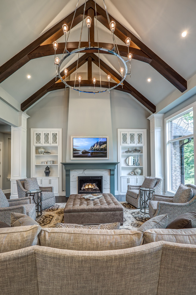 Large classic open plan living room in Cincinnati with grey walls, dark hardwood flooring, a standard fireplace, a tiled fireplace surround, a wall mounted tv and brown floors.