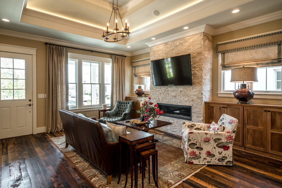 Inspiration for a traditional living room in Louisville with beige walls, dark hardwood flooring, a ribbon fireplace, a stone fireplace surround and a wall mounted tv.