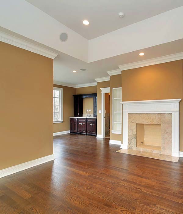 This is an example of a classic formal enclosed living room in Louisville with brown walls, dark hardwood flooring, no fireplace and no tv.