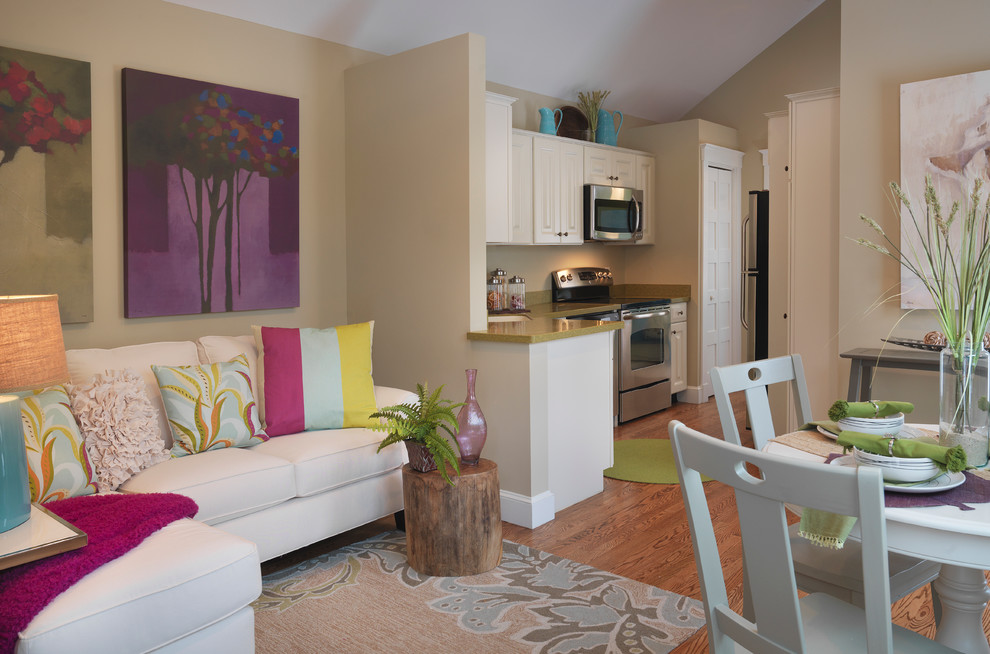 Inspiration for a small contemporary open concept medium tone wood floor living room remodel in Other with beige walls