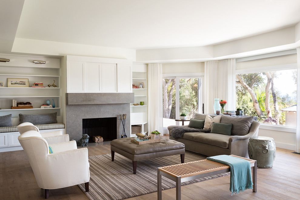 This is an example of a classic formal living room in Santa Barbara with white walls, light hardwood flooring, a stone fireplace surround and a standard fireplace.