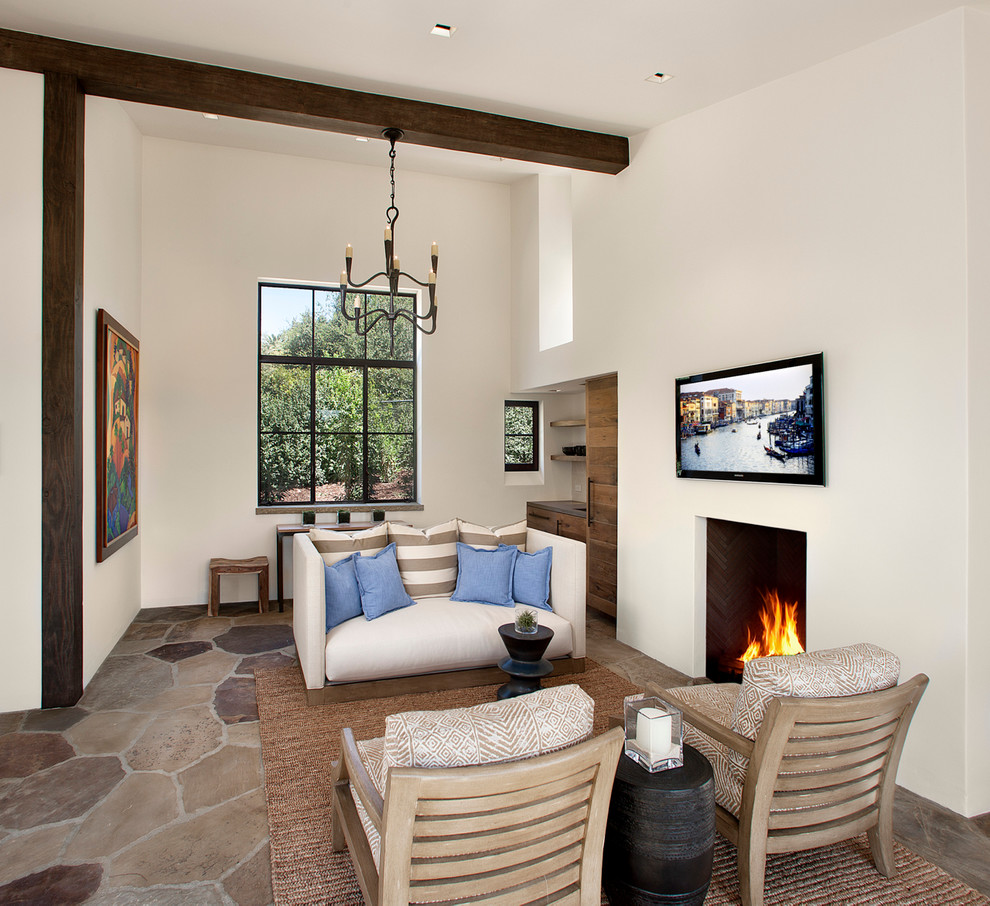 Medium sized mediterranean formal open plan living room in Santa Barbara with white walls, a standard fireplace and a wall mounted tv.