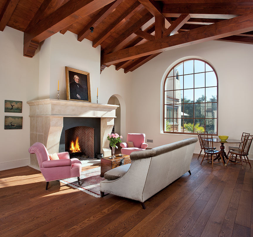 Living room - large mediterranean enclosed dark wood floor living room idea in Santa Barbara with white walls, a standard fireplace, a stone fireplace and no tv