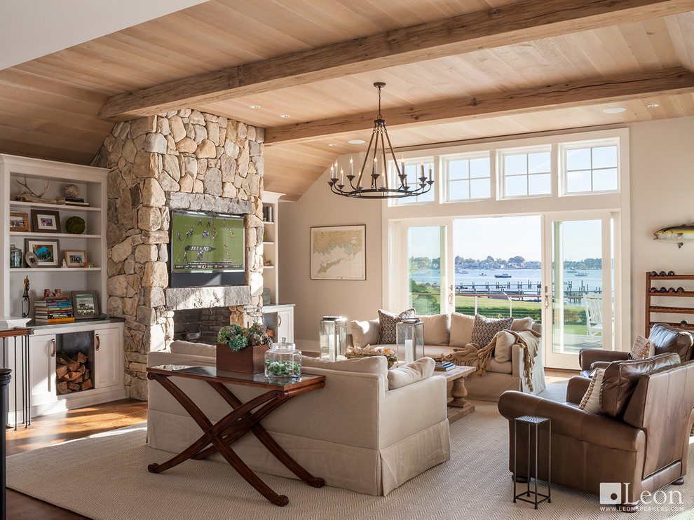Medium sized nautical enclosed living room in Bridgeport with beige walls, medium hardwood flooring, a standard fireplace, a stone fireplace surround and a built-in media unit.