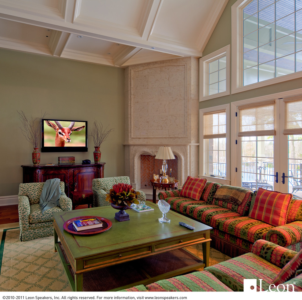 Example of a large classic open concept medium tone wood floor living room design in Detroit with green walls, a corner fireplace, a stone fireplace and a wall-mounted tv