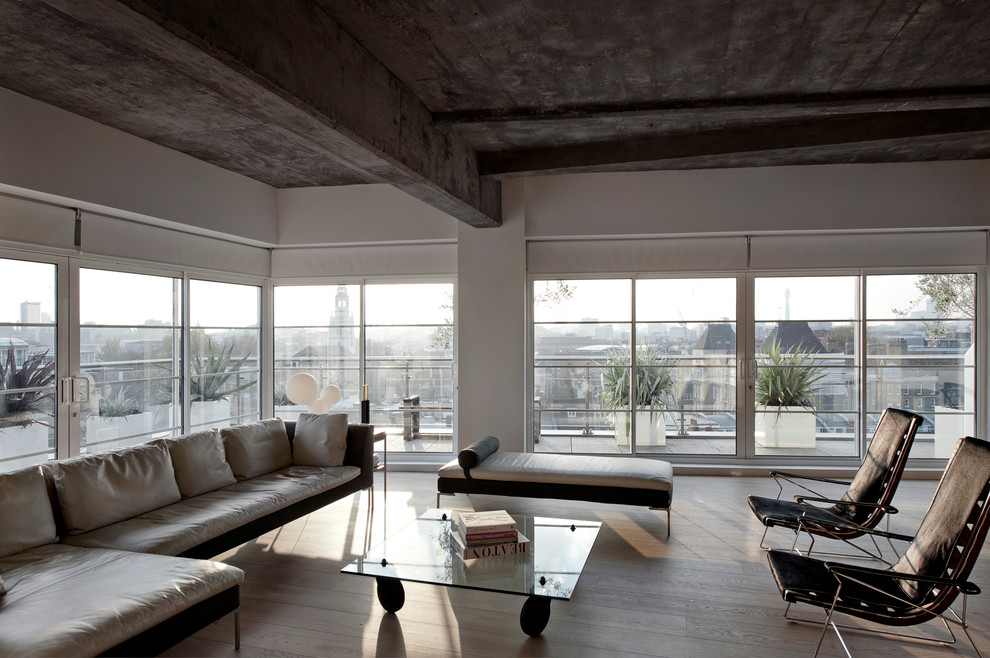 Design ideas for an urban formal living room in New York with light hardwood flooring.