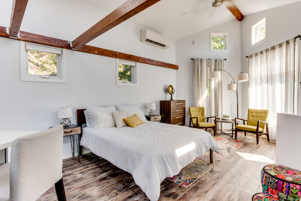 Foto de dormitorio clásico renovado pequeño sin chimenea con paredes blancas, suelo de madera en tonos medios y suelo marrón
