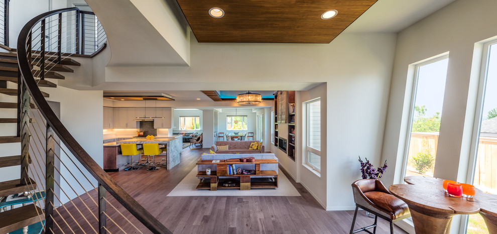 Inspiration for a large contemporary open concept brown floor and medium tone wood floor living room remodel in Seattle with white walls