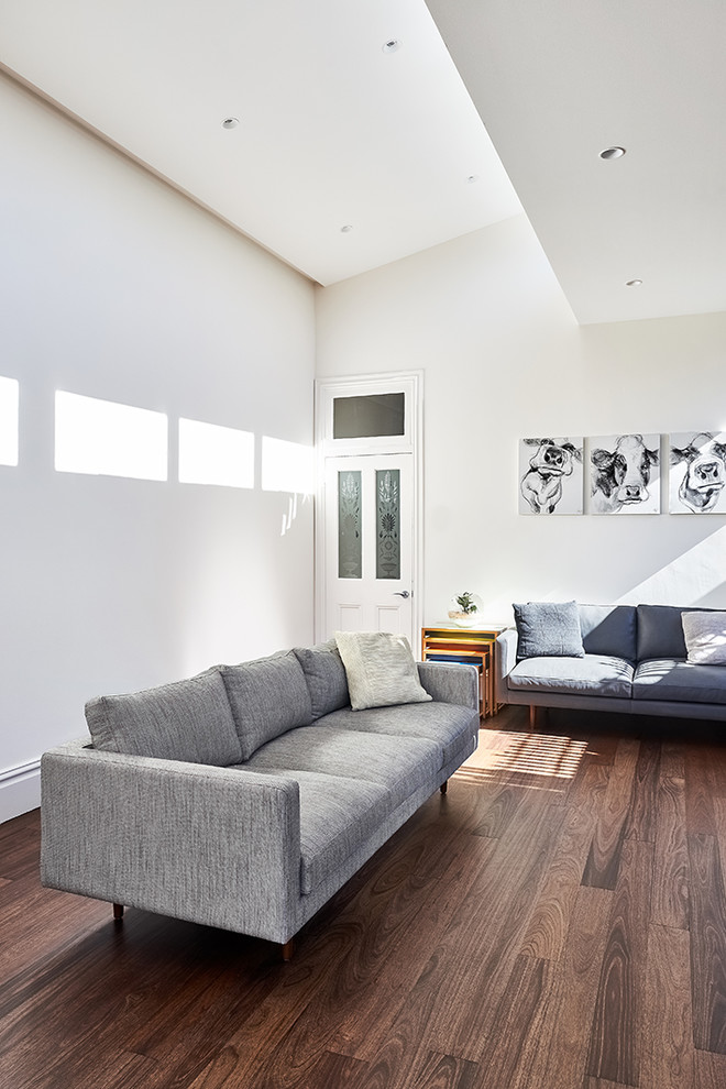 Photo of a medium sized contemporary open plan living room in Sydney with a home bar, white walls, dark hardwood flooring, a standard fireplace, a concrete fireplace surround and a wall mounted tv.