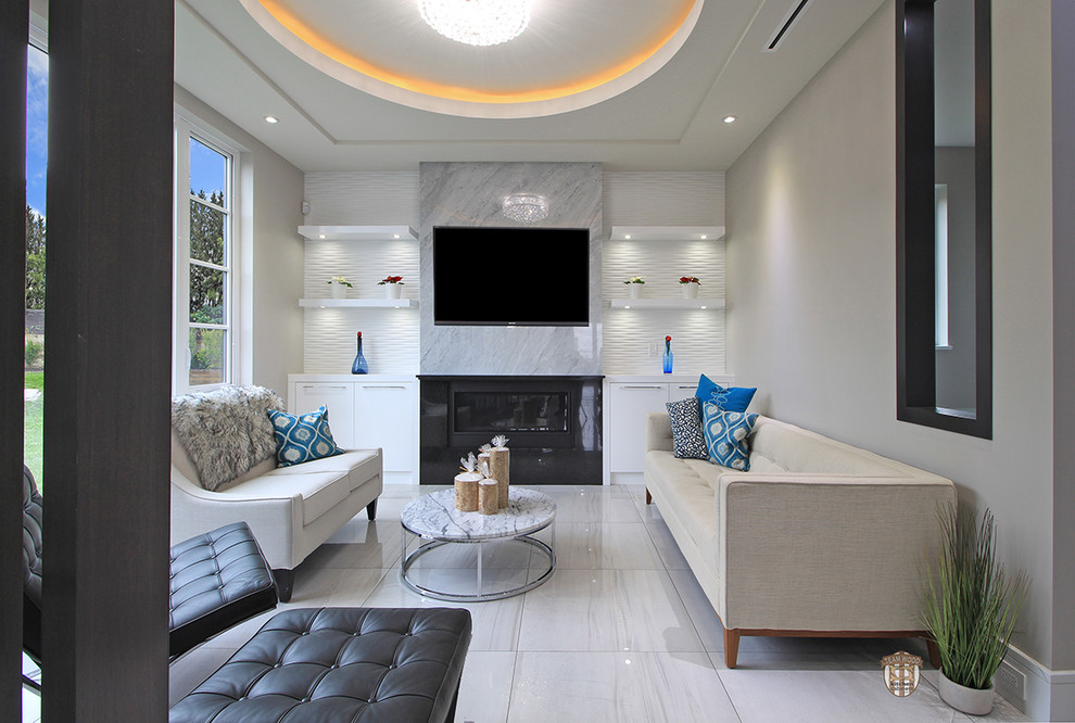 Example of a mid-sized minimalist formal and open concept porcelain tile and gray floor living room design in Vancouver with white walls, a standard fireplace, a stone fireplace and a wall-mounted tv