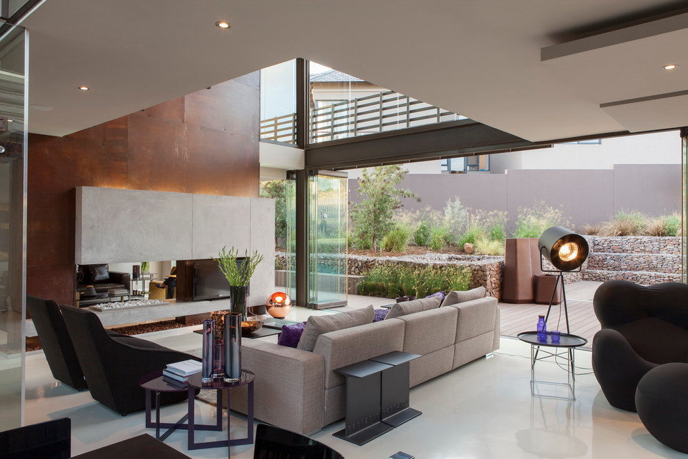 Contemporary open plan living room in Other with a two-sided fireplace and a wall mounted tv.