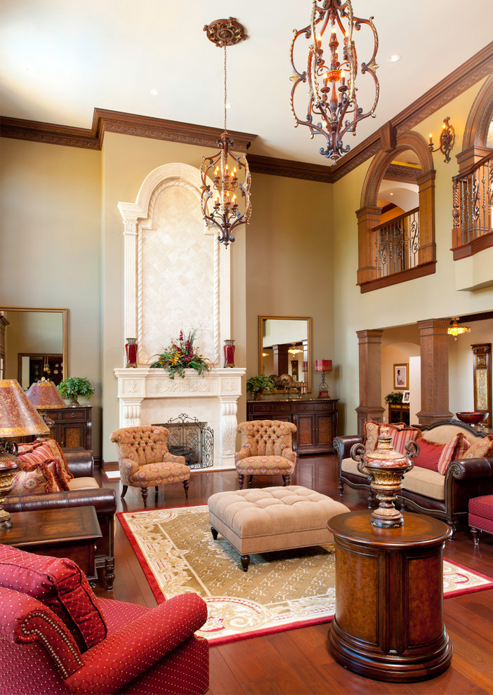 Diseño de salón para visitas tradicional con paredes beige, suelo de madera oscura y todas las chimeneas