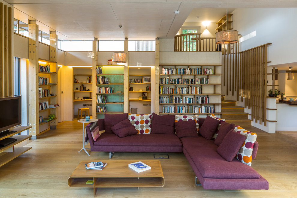 Mid-sized trendy open concept light wood floor living room photo in London with white walls