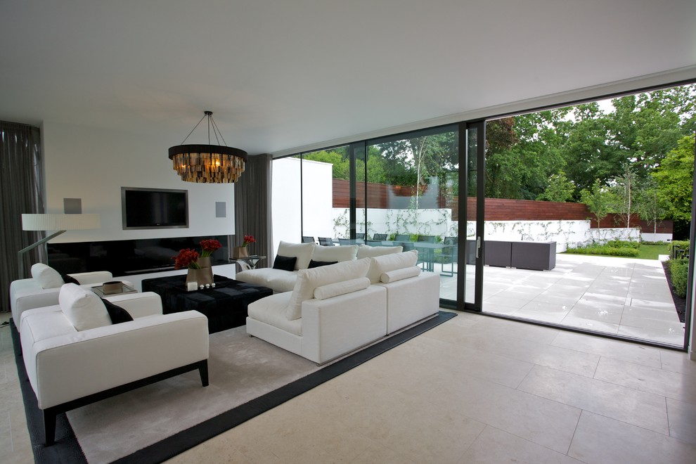 Inspiration for a contemporary living room in London with white walls, a wall mounted tv and feature lighting.
