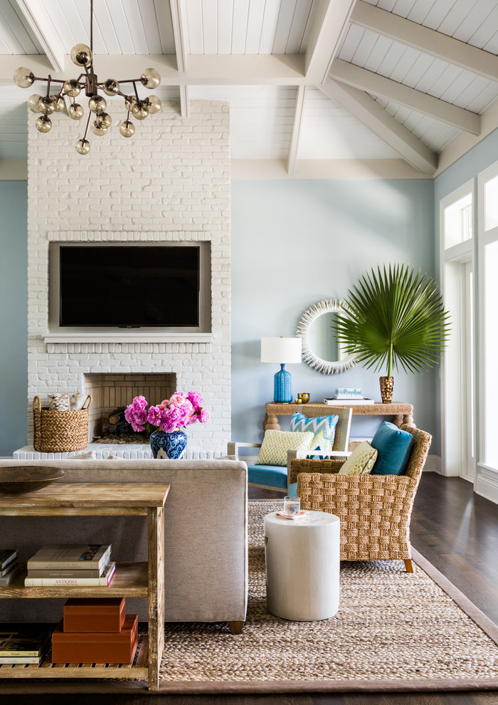 Beach style formal dark wood floor living room photo in Jacksonville with blue walls, a standard fireplace and a wall-mounted tv
