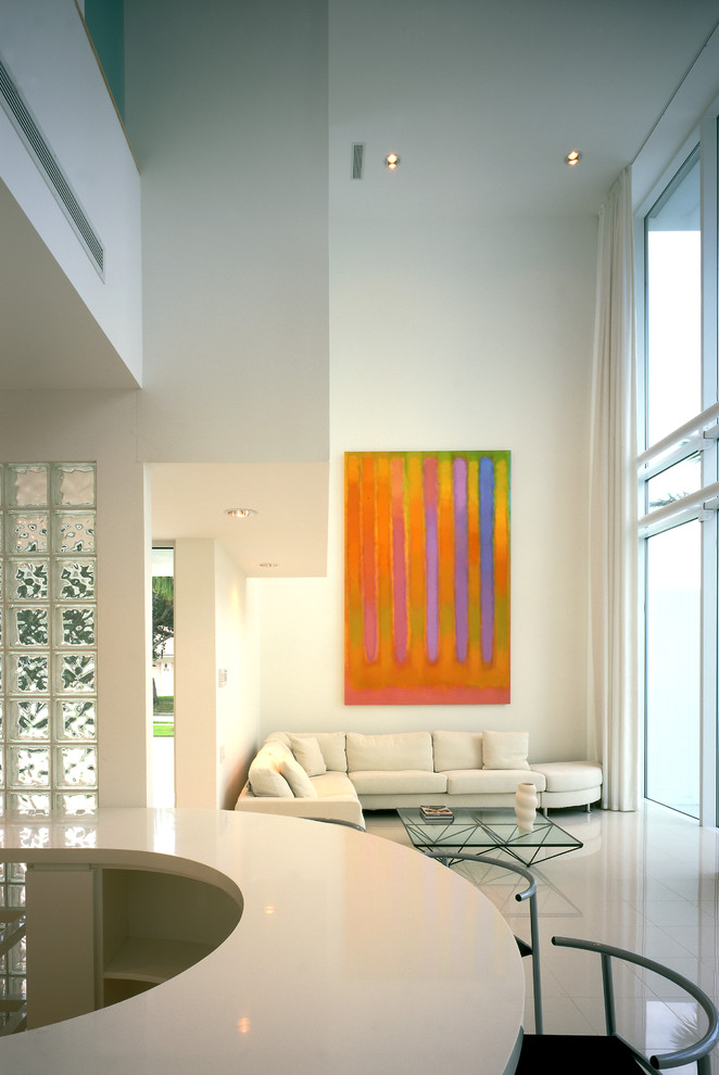 This is an example of a modern open plan living room in Tampa with white walls.