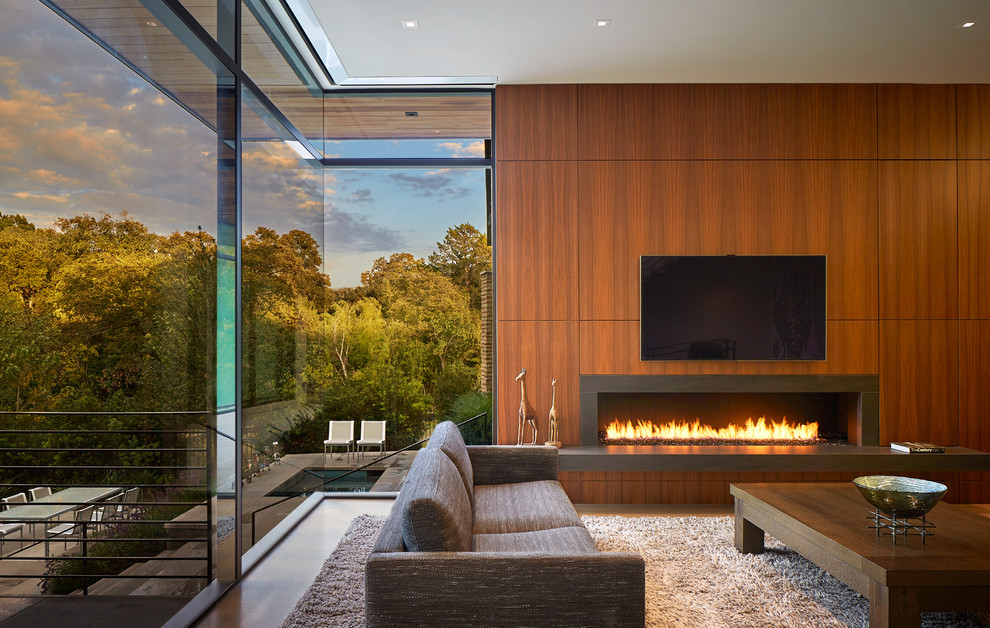 Inspiration for a large contemporary formal enclosed living room in Dallas with a ribbon fireplace, brown walls, porcelain flooring, a metal fireplace surround, a wall mounted tv and beige floors.