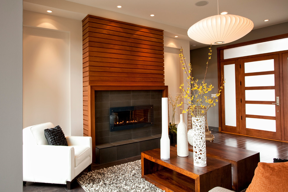 Contemporary open plan living room in Vancouver with a ribbon fireplace, white walls, dark hardwood flooring and a wooden fireplace surround.