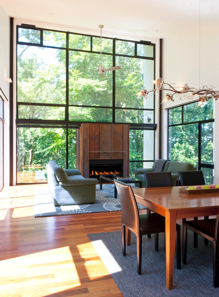 Inspiration pour un salon design ouvert avec un mur blanc, un sol en bois brun et une cheminée ribbon.