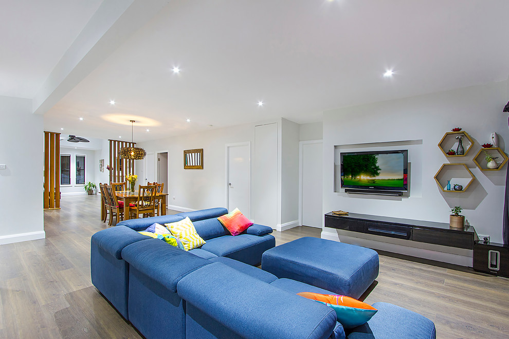 Großes, Repräsentatives, Offenes Modernes Wohnzimmer ohne Kamin mit grauer Wandfarbe, hellem Holzboden und TV-Wand in Sydney