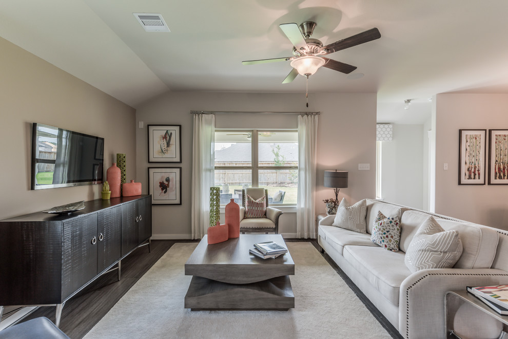 This is an example of a medium sized contemporary open plan living room in Houston with beige walls, dark hardwood flooring, a wall mounted tv and brown floors.