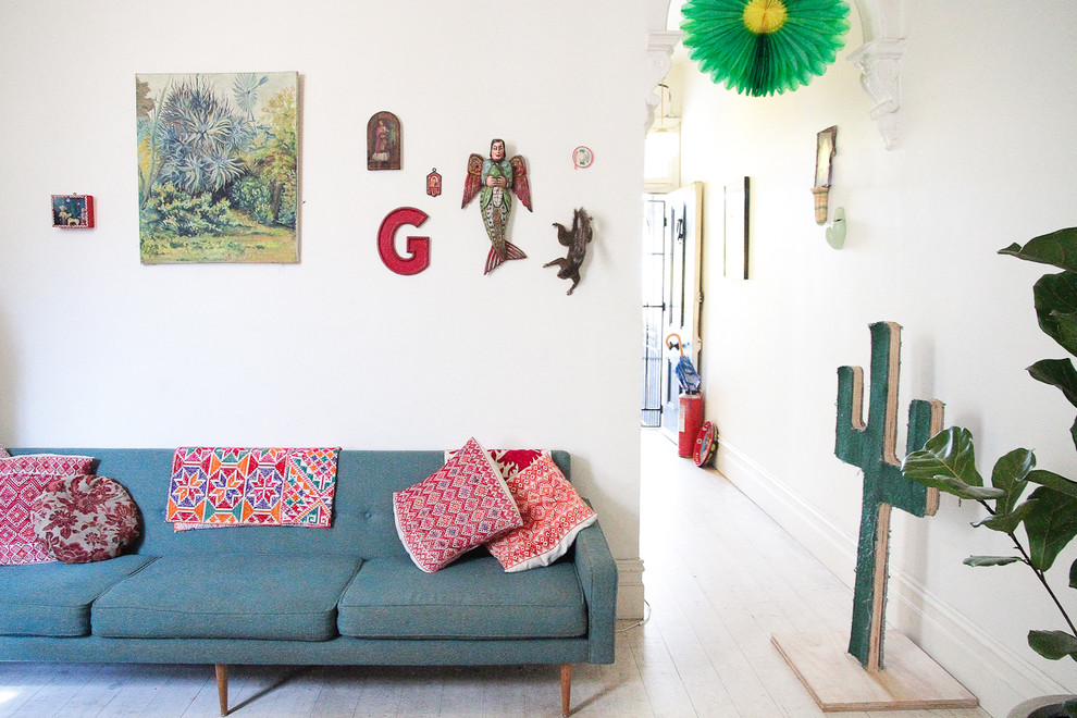 Eclectic living room photo in Melbourne with white walls
