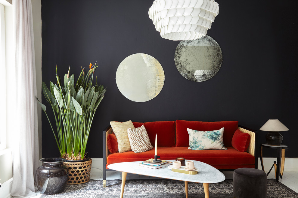 Inspiration for a mid-sized transitional painted wood floor and white floor living room remodel in London with black walls