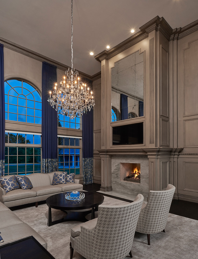 This is an example of an expansive traditional formal open plan living room in Detroit with grey walls, dark hardwood flooring, a built-in media unit, a two-sided fireplace and a stone fireplace surround.