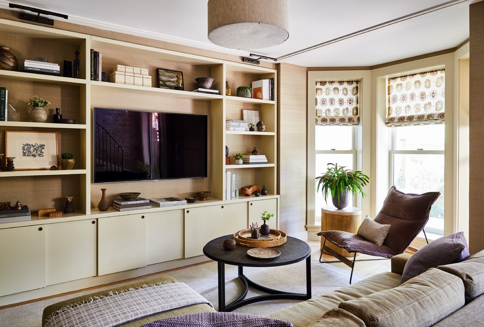 Photo of a classic living room in New York with beige walls, medium hardwood flooring, a built-in media unit and brown floors.