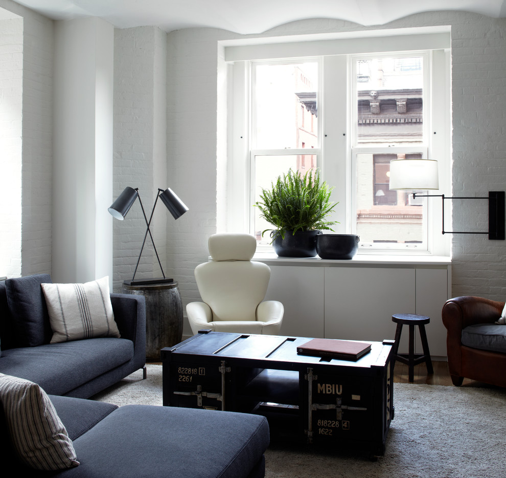 Example of a trendy living room design in New York with white walls