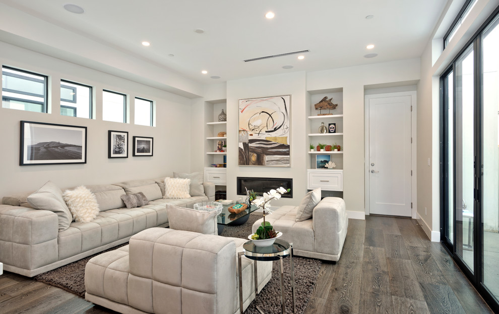 Medium sized modern formal open plan living room in Orange County with white walls, medium hardwood flooring, a ribbon fireplace, a metal fireplace surround and grey floors.