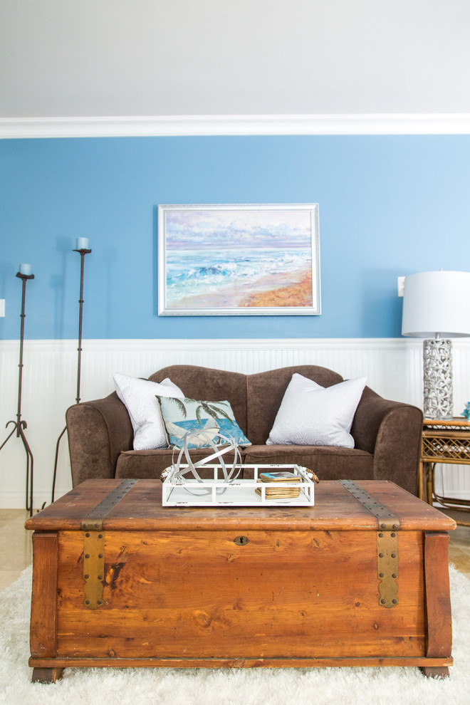Immagine di un soggiorno stile marino di medie dimensioni e aperto con pareti blu, pavimento con piastrelle in ceramica, nessun camino e pavimento beige