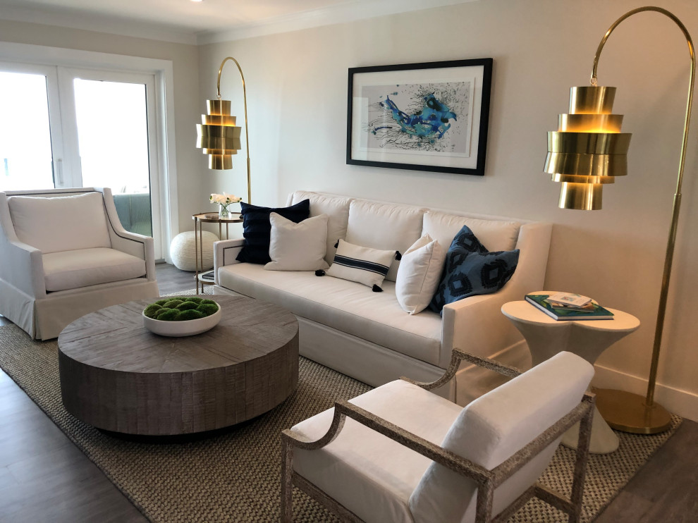 Small beach style open concept vinyl floor and gray floor living room photo in Miami with white walls, a standard fireplace, a tile fireplace and a media wall