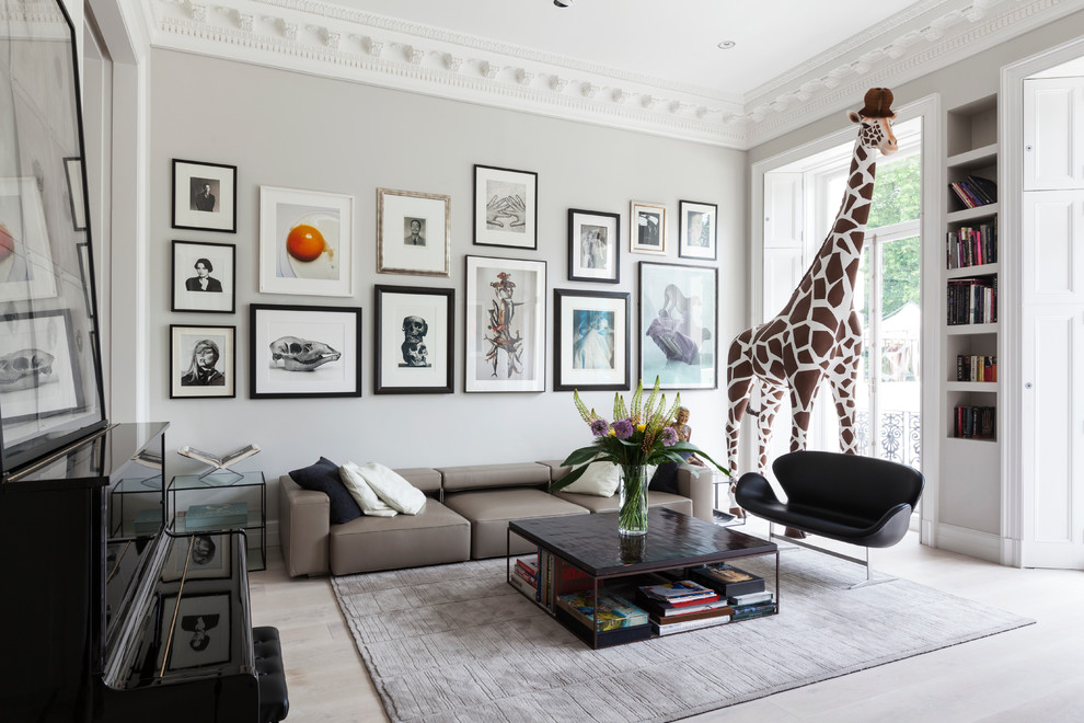 Living room - large contemporary formal and open concept light wood floor living room idea in London with gray walls