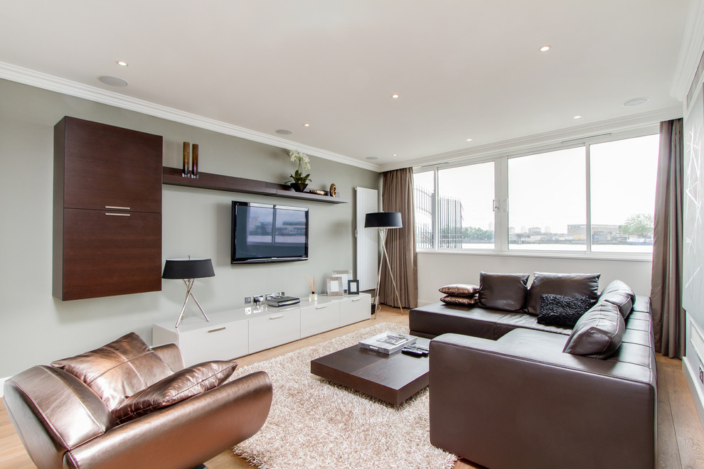 Trendy living room photo in London with gray walls and a wall-mounted tv