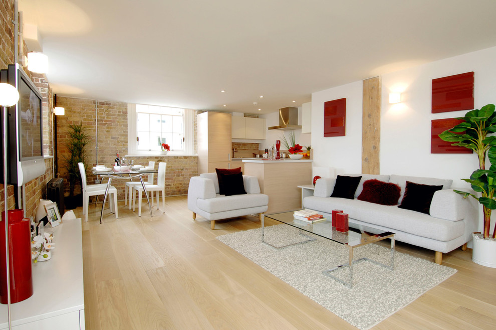 Modernes Wohnzimmer mit weißer Wandfarbe, hellem Holzboden und TV-Wand in Venedig
