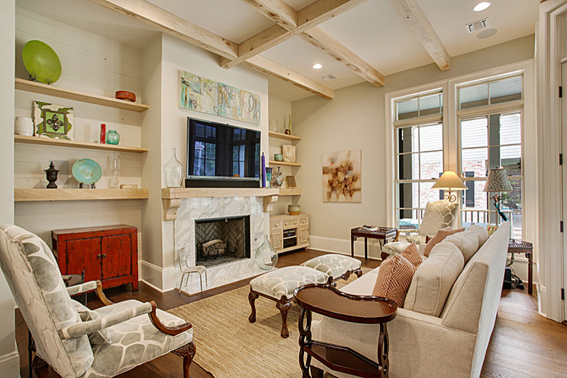 Photo of a medium sized farmhouse open plan living room in New Orleans with beige walls, medium hardwood flooring, a standard fireplace, a tiled fireplace surround and a wall mounted tv.