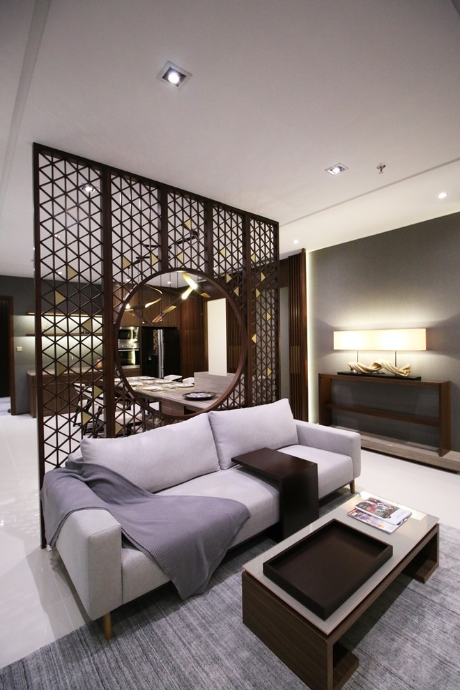 Imagen de salón con barra de bar abierto asiático pequeño sin chimenea con paredes beige, suelo de baldosas de porcelana y pared multimedia