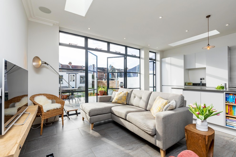Photo of a contemporary open plan living room in Hampshire with grey floors.