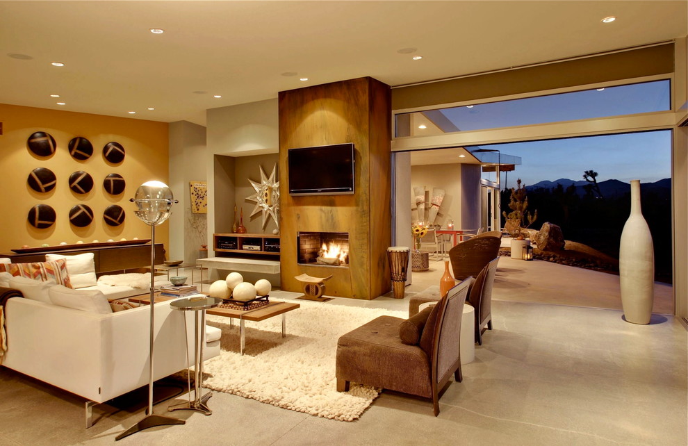 Living room - large mid-century modern open concept concrete floor living room idea in Los Angeles with beige walls, a standard fireplace and a wall-mounted tv