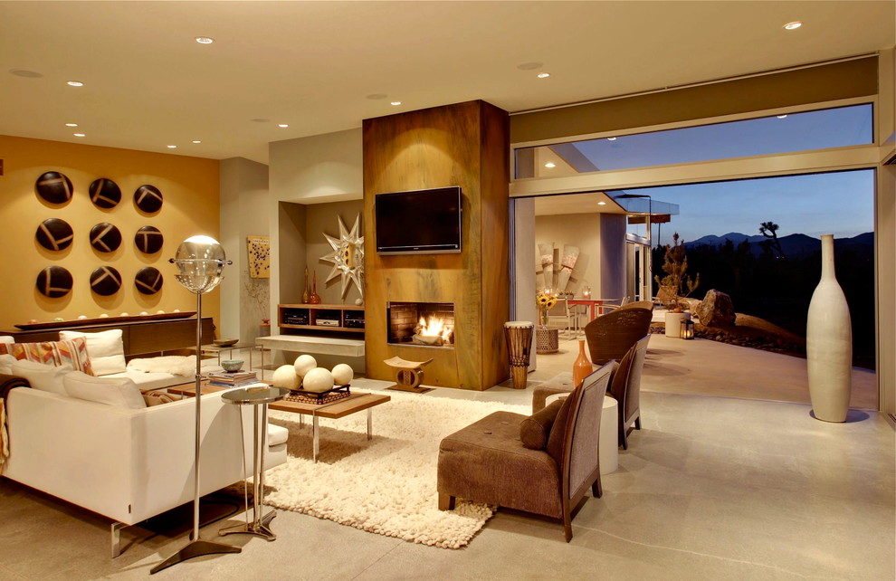 Design ideas for a large midcentury open plan living room in Los Angeles with beige walls, concrete flooring, a standard fireplace and a wall mounted tv.