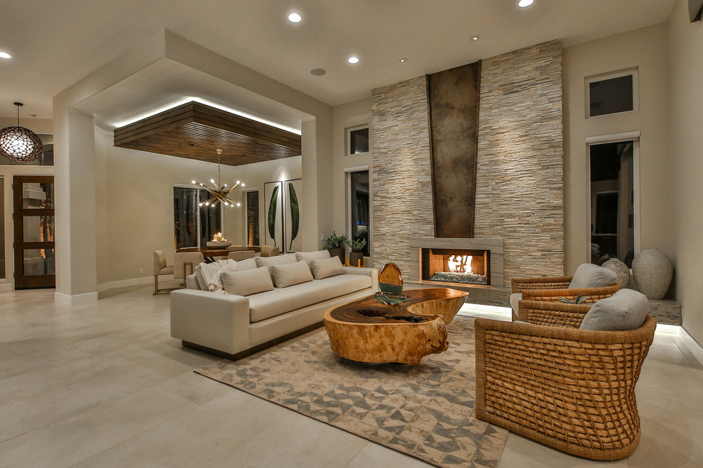 Photo of a medium sized contemporary formal open plan living room in Other with beige walls, travertine flooring, a ribbon fireplace, a stone fireplace surround, no tv and beige floors.